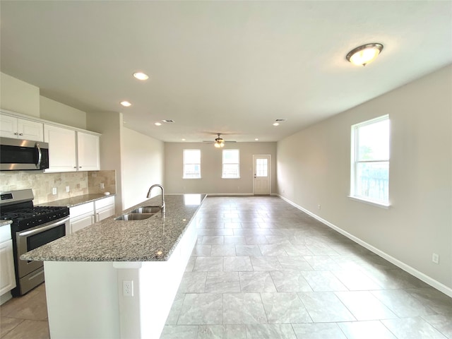 kitchen featuring a healthy amount of sunlight, sink, appliances with stainless steel finishes, and white cabinetry