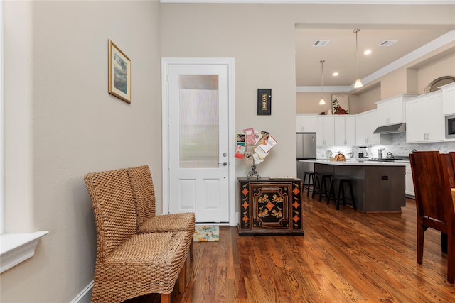 interior space featuring visible vents and dark wood-style flooring