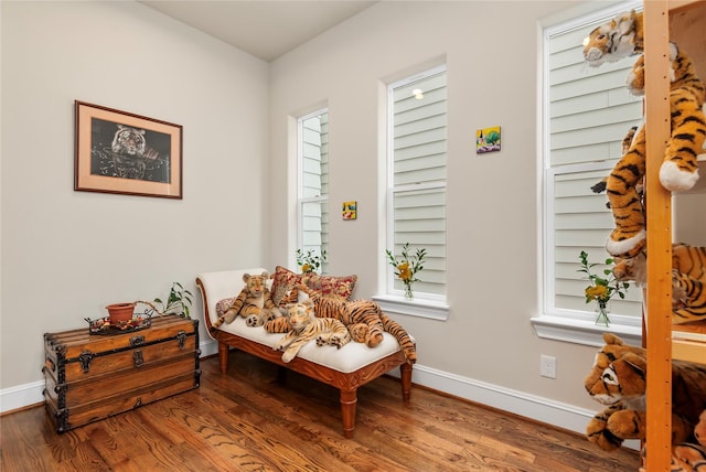 living area with wood finished floors and baseboards