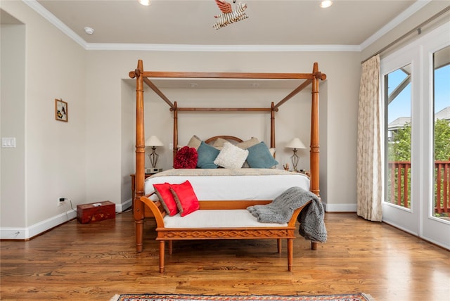 bedroom with ornamental molding, baseboards, and wood finished floors