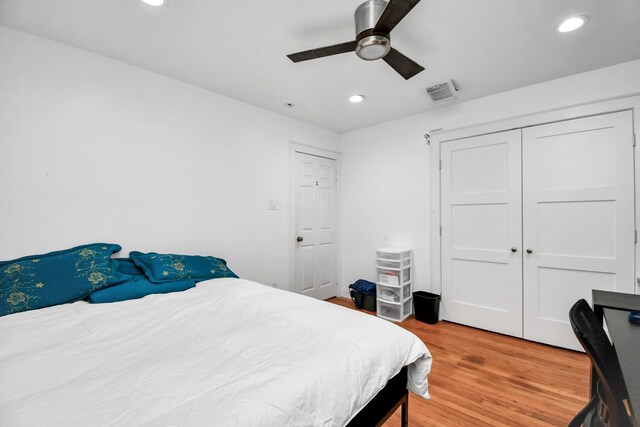 bedroom with ceiling fan, a closet, and light wood-type flooring