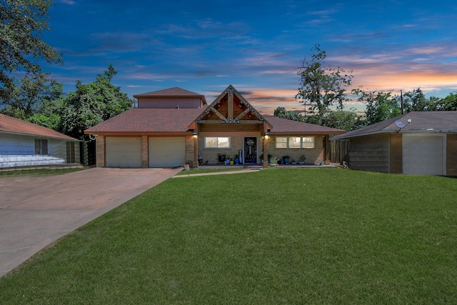 view of front of home with a lawn and a garage