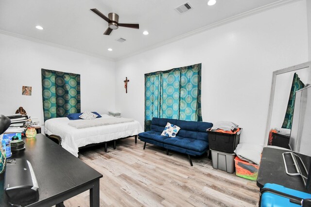 bedroom with ceiling fan, light hardwood / wood-style floors, and ornamental molding