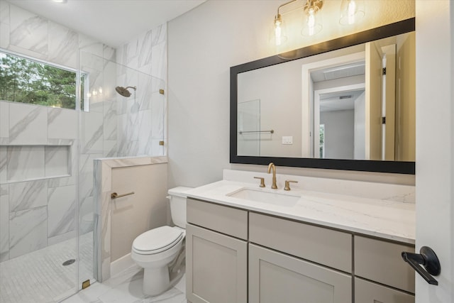 bathroom featuring vanity, toilet, and a shower with shower door