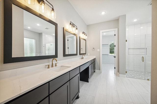 bathroom with a shower with door and vanity