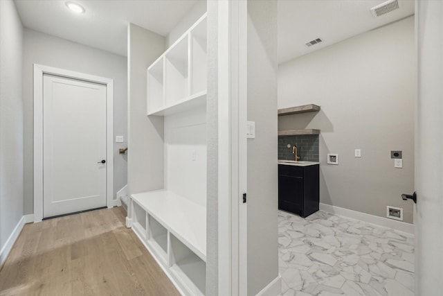 mudroom featuring sink and light hardwood / wood-style floors