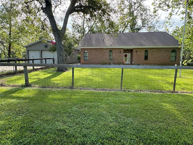 back of property featuring an outbuilding, a lawn, and a garage