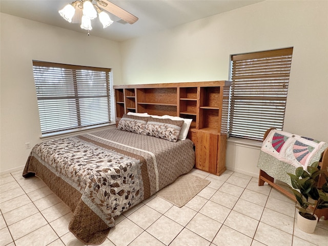 bedroom with ceiling fan and light tile patterned floors