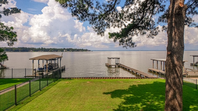 dock area featuring a lawn and a water view