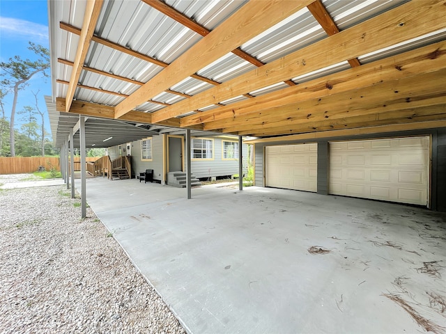 view of parking / parking lot featuring a garage and a carport