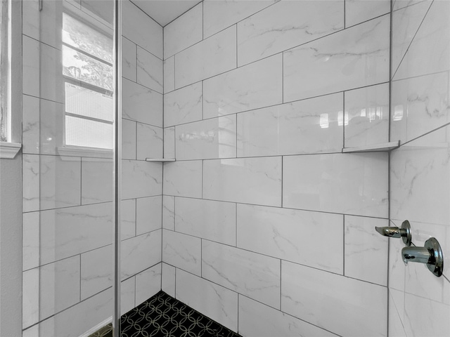 bathroom with tiled shower