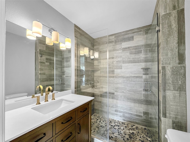 bathroom with vanity, toilet, and an enclosed shower