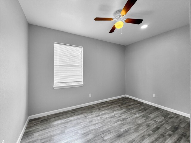 spare room with ceiling fan and wood-type flooring