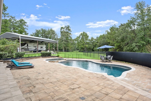 view of swimming pool featuring a patio, an in ground hot tub, and a yard