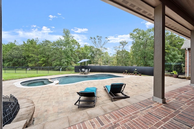 view of swimming pool with a patio area and an in ground hot tub