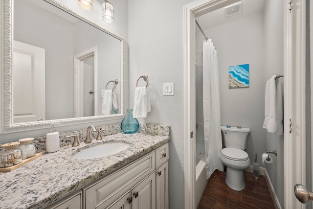 full bathroom featuring vanity, shower / bath combo, and toilet