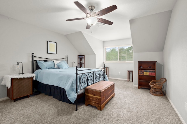 carpeted bedroom with ceiling fan and vaulted ceiling