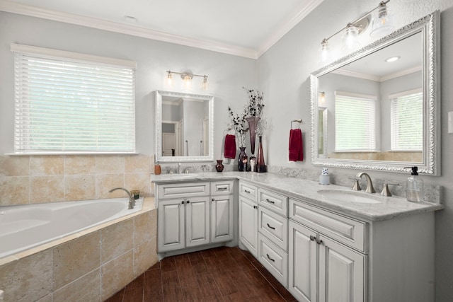 bathroom featuring crown molding, vanity, a relaxing tiled tub, and hardwood / wood-style floors