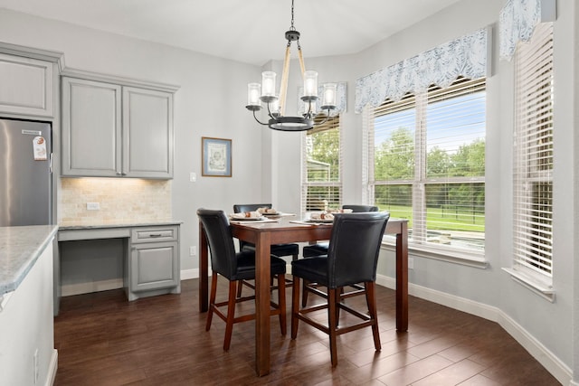 dining room featuring dark wood-type flooring and a notable chandelier