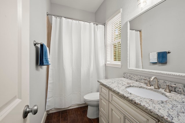 bathroom featuring vanity, a shower with curtain, hardwood / wood-style floors, and toilet