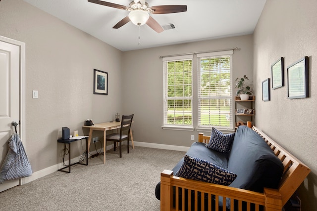 carpeted office space with ceiling fan