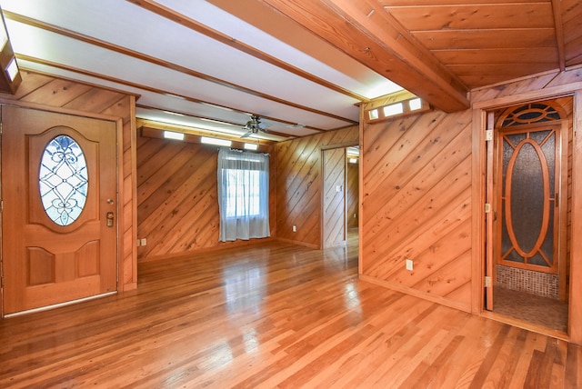 foyer featuring wood walls, ceiling fan, and hardwood / wood-style flooring