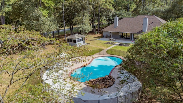 view of pool featuring a patio, an outbuilding, and a lawn