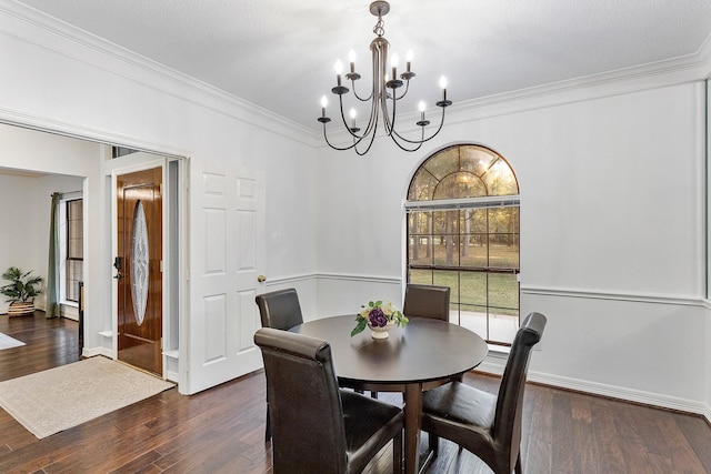 dining area featuring ornamental molding and dark hardwood / wood-style flooring