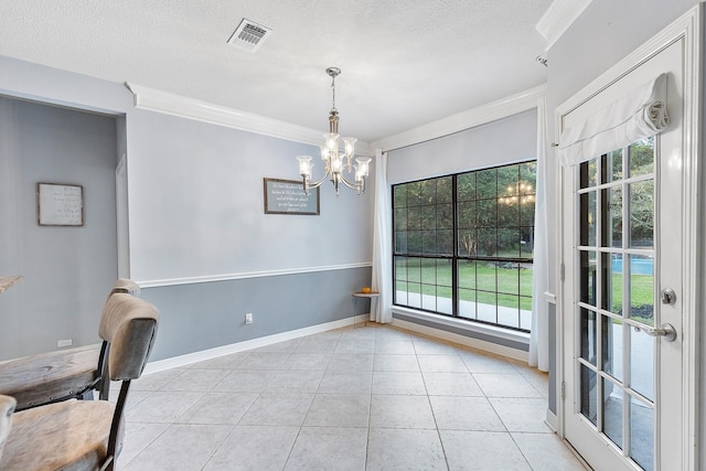 unfurnished dining area with a notable chandelier, ornamental molding, a textured ceiling, and light tile patterned flooring