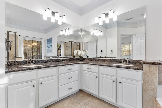 bathroom with crown molding, vanity, tile patterned floors, and walk in shower