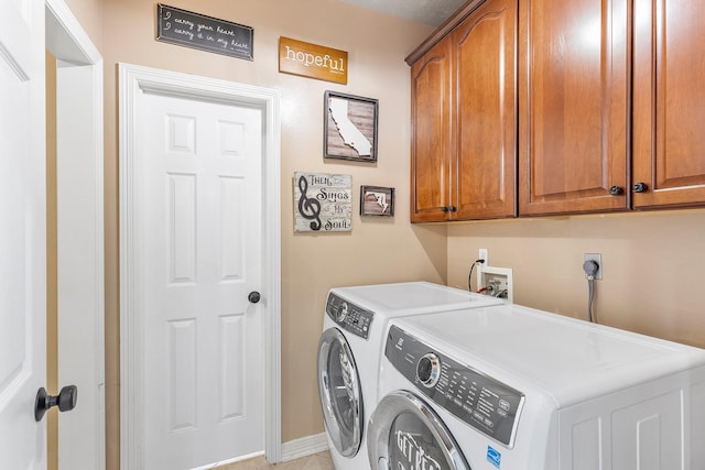 laundry room featuring cabinets and washer and dryer