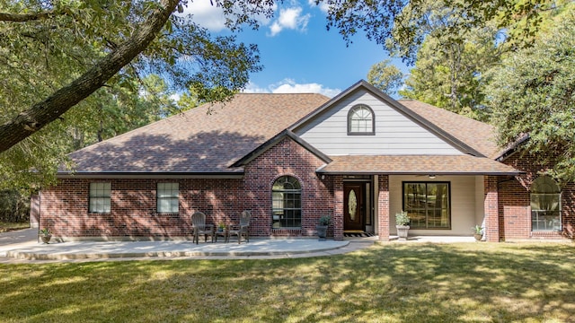 view of front of property with a front yard and a patio