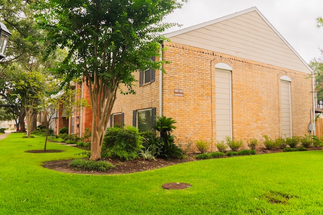 view of side of home with a yard