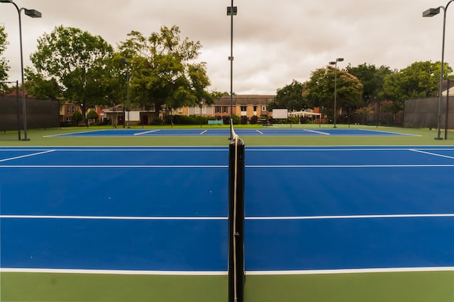 view of tennis court featuring basketball court