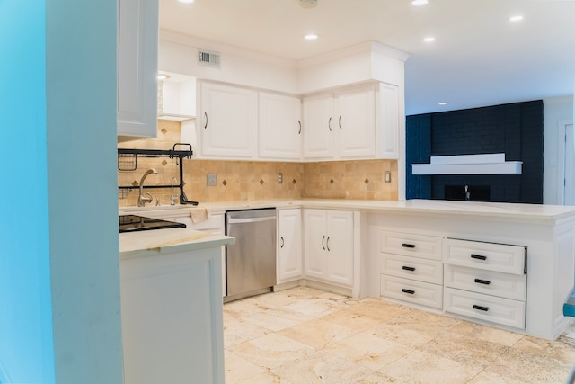 kitchen with tasteful backsplash, sink, white cabinetry, and stainless steel dishwasher