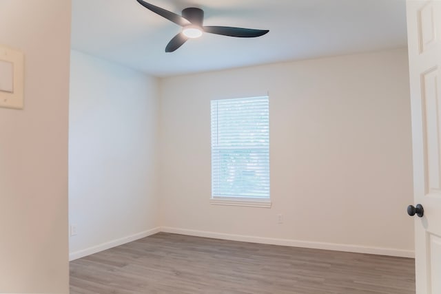 spare room with hardwood / wood-style floors and ceiling fan