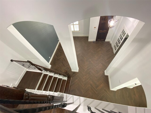 interior space featuring an inviting chandelier and dark parquet floors