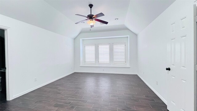 empty room with lofted ceiling, ceiling fan, and dark hardwood / wood-style floors