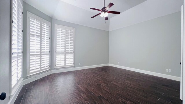 spare room featuring a wealth of natural light, ceiling fan, and dark hardwood / wood-style floors