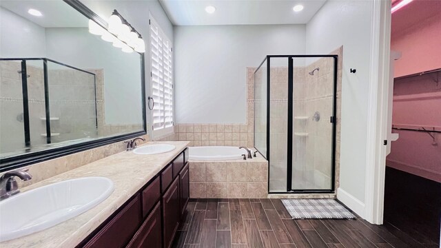 bathroom with vanity, wood-type flooring, and separate shower and tub