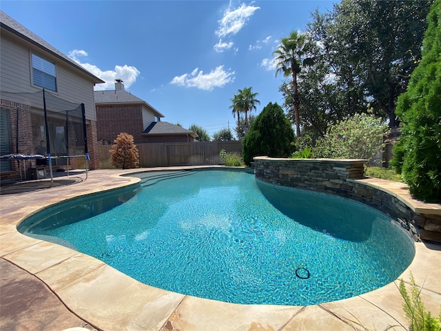 view of pool with a trampoline