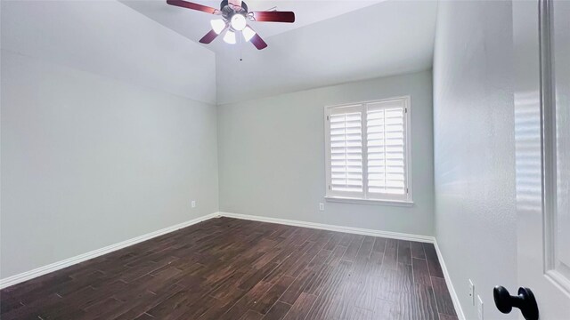 empty room featuring dark wood-type flooring, ceiling fan, and vaulted ceiling