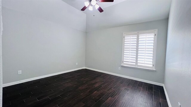 empty room featuring lofted ceiling, ceiling fan, and dark hardwood / wood-style floors