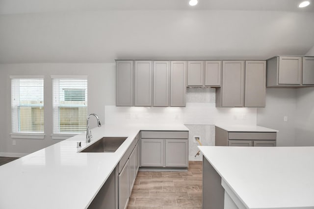 19722 Vino Vale Dr, Hockley, TX 77447 - kitchen with a sink, gray cabinetry, recessed lighting, decorative backsplash, and light wood-style floors