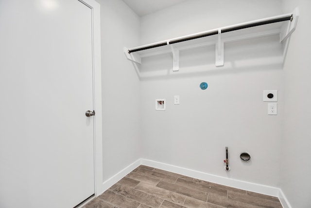 laundry area with hookup for a washing machine, hardwood / wood-style flooring, hookup for an electric dryer, and gas dryer hookup