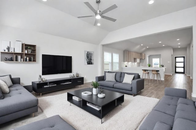 living room with high vaulted ceiling, a healthy amount of sunlight, and ceiling fan