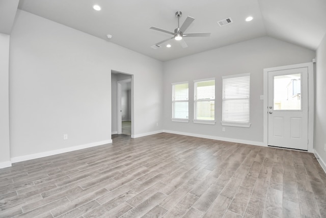 unfurnished living room featuring light hardwood / wood-style flooring, ceiling fan, and vaulted ceiling