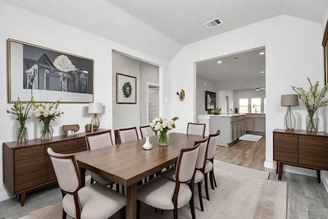 19722 Vino Vale Dr, Hockley, TX 77447 - dining room with light wood-style flooring, lofted ceiling, and recessed lighting