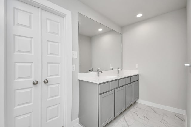 19722 Vino Vale Dr, Hockley, TX 77447 - bathroom featuring baseboards, marble look tile flooring, recessed lighting, and double vanity