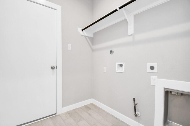 washroom featuring hookup for a washing machine, electric dryer hookup, light hardwood / wood-style floors, and gas dryer hookup